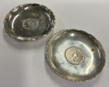 A pair of small Chinese silver pin dishes set with