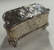 A silver jewellery box with embossed cherub decora