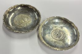 A pair of circular Chinese silver pin dishes set w