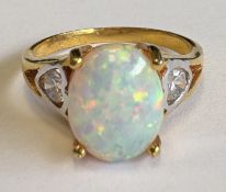 A small three-stone opal ring in claw mount.