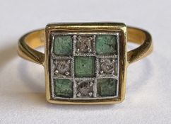 An attractive nine-stone emerald and diamond ring in 18 carat gold setting.