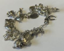 A silver curb link charm bracelet.
