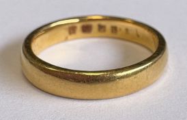 A plain 22 carat gold wedding band.