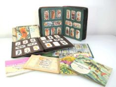 Three albums containing a collection of cigarette cards, mostly Players and Wills, together with six