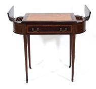 An Edwardian mahogany, ebony strung and satinwood banded writing table, the tooled leather surface