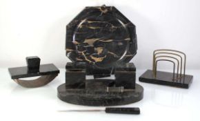 An Art Deco black marble/hardstone four piece desk set comprising letter rack, blotter, inkstand and