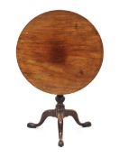 A George III mahogany circular tilt-top table with a birdcage mechanism, turned column and three