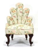 A Victorian and later upholstered lounge chair of shell form on turned mahogany legs with castors