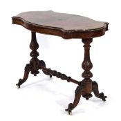 A Victorian quarter-sawn walnut centre table of serpentine form on foliate columns joined by a cross