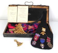 A group of Masonic regalia including three silver gilt and two base metal jewels, a sash, ephemera