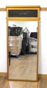 A pier mirror, the gilt painted frame with a single black panel over the rectangular glass plate,