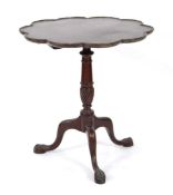 An early-to-mid 20th century mahogany tilt-top wine or occasional table on a turned column and three