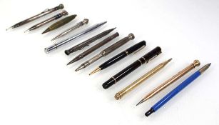 A group of propelling pencils, including some silver examples, together with a fountain pen and a