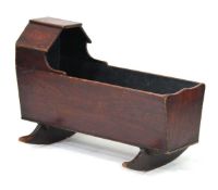 A 19th century provincial stained elm child's crib on sleigh rockers