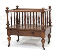 A Victorian mahogany three-compartment canterbury with a single drawer, on turned legs with castors