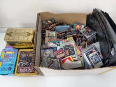 Box of various Pokémon and Yu-Gi-Oh cards, Football stickers and penny sleeves Where possible
