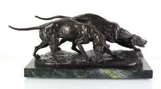 A 20th century bronze sculptural group modelled as a pair of hunting hounds on a naturalistic
