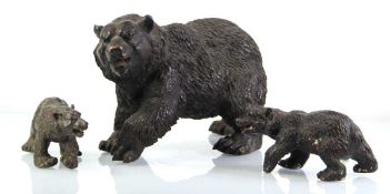 A brown-patinated metalwares figure modelled as a snarling bear, w. 35 cm, together with two smaller