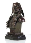 A 20th century bronze bust modelled as a Native American in headdress, signed Milo, on a marble