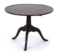 A 19th century mahogany tilt-top table, the circular surface on a short turned column and three