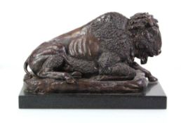 A 20th century bronze sculpture modelled as a seated bison, unsigned, on a marble plinth, w. 34