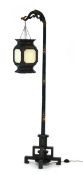 A 20th century standard lamp decorated in the chinoiserie manner, the green lacquered shaft