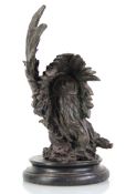 A 20th century bronze sculpture modelled as a Native American and eagle, unsigned, on a marble