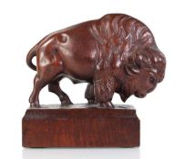 A carved oak sculpture modelled as a bison, initialled JB to the base, h. 18 cm, together with two