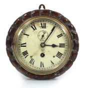 An early 20th century bulkhead timepiece by Dent of London, the painted face with Roman numerals,