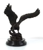 A bronze sculpture modelled as an eagle with outstretched wings, on a marble plinth, h. 37 cm