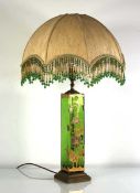 A 20th century table lamp, the green glass body with gilt Aesthetic Movement style decoration,