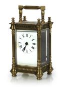 A late 19th/early 20th century carriage timepiece, the enamelled dial with black Roman numerals,