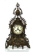 A late 19th century mantle clock, the enamelled 3.5 inch face with Arabic numerals, the movement