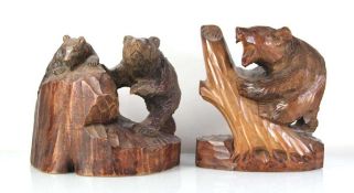 A Black Forest style carved sculpture modelled as a bear climbing a tree, h. 28 cm, together with