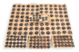 A collection of approximately one-hundred and eighty brown-patinated brass buttons relief