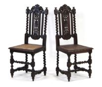 A pair of Victorian oak and bergère hall chairs, the foliate splats with barley twist columns to