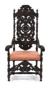 A 19th century oak hall chair in the 17th century manner, with a heavily carved back over an