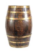 An umbrella and stick stand modelled as a brass-bound barrel with a drip tray to the inside, h. 62