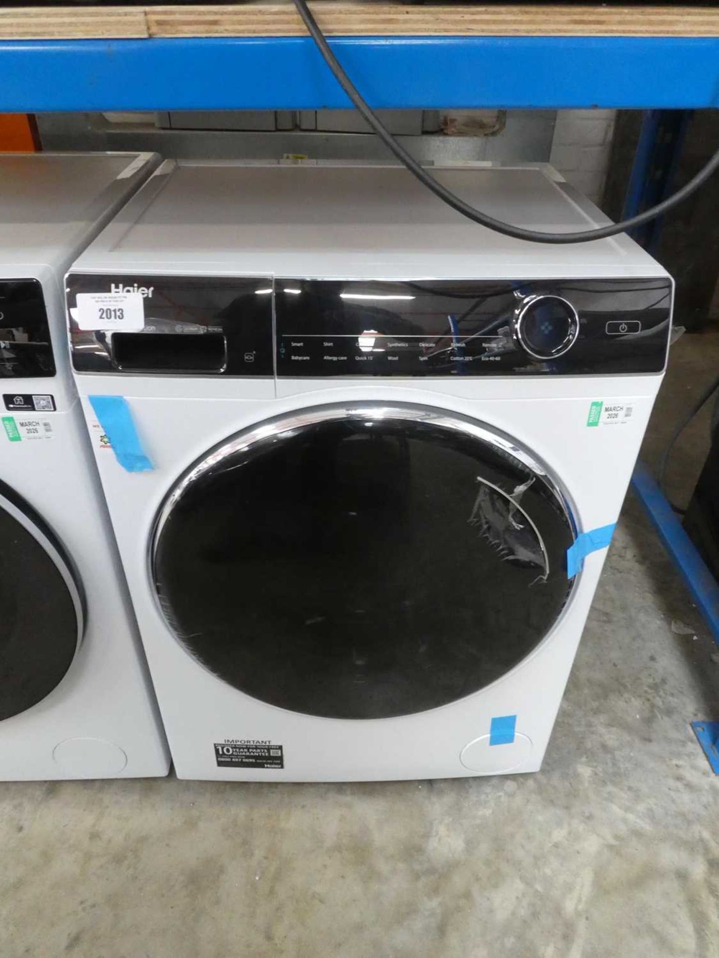 +VAT Haier Direct Motion washing machine in black and white