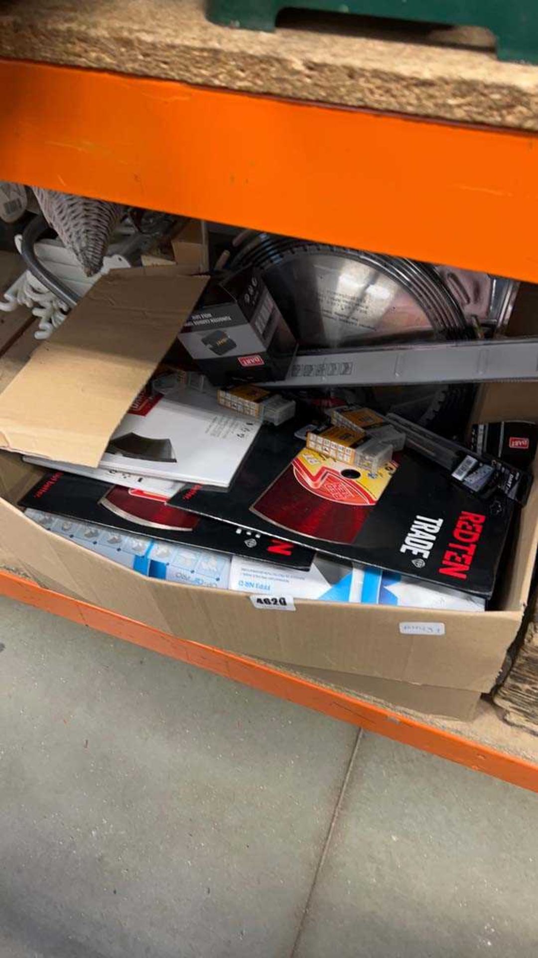 Box of items including dart related items, dart carbide hole saw, circular saw blades, twist drill