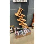 Box of DVDs and a wooden storage rack