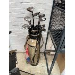 Gold and black golf bag containing a quantity of mix branded golf clubs to include Cobra XL