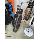 Golden Bear branded golf bag containing a quantity of Golden Bear branded golf clubs