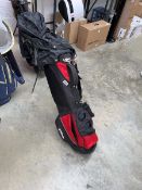 Wilson branded red and black golf bag containing a quantity of mainly Prosimmon branded golf clubs
