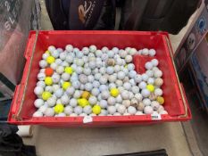 Large red crate containing mixed golf balls