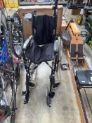Black metal framed 4 wheel folding wheelchair