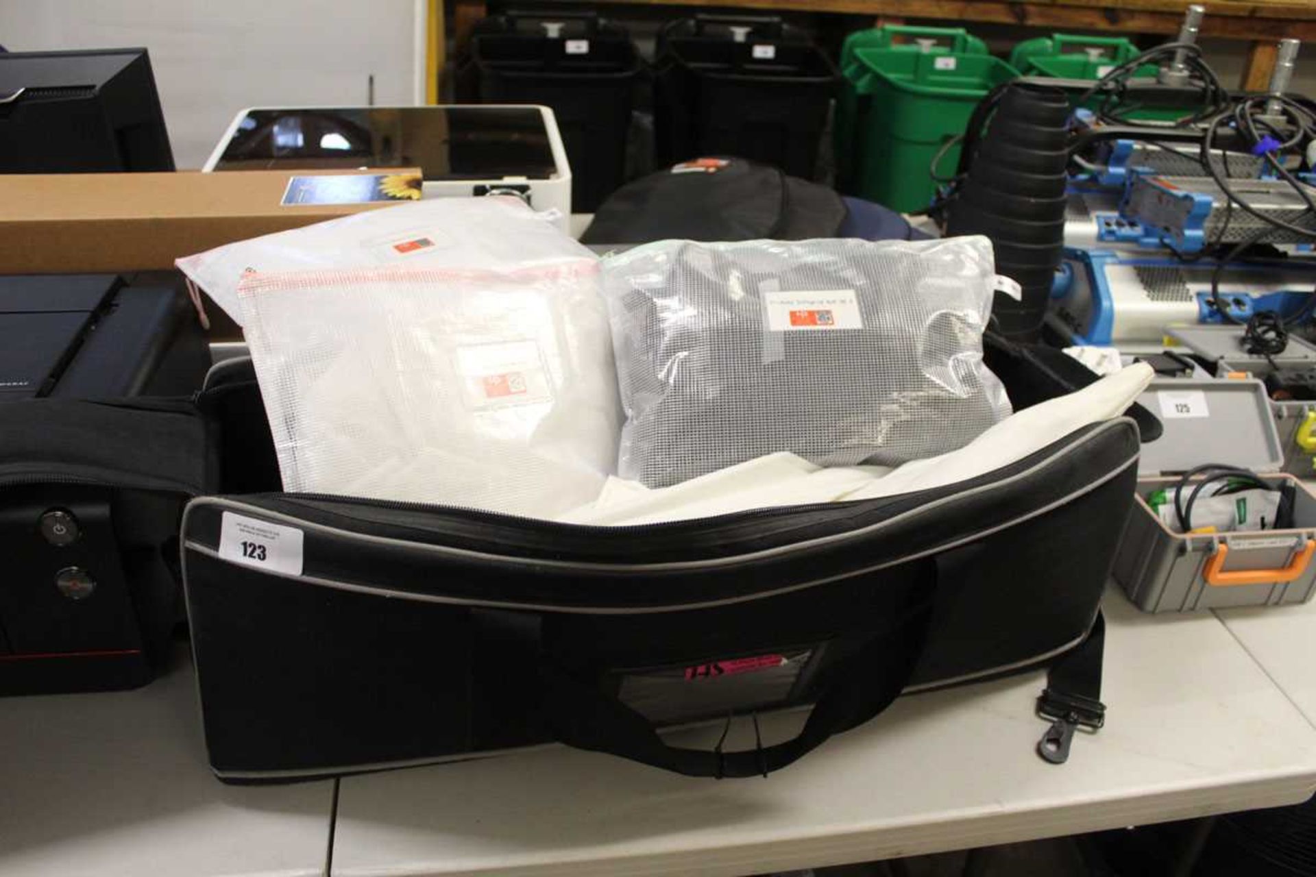 +VAT Zip up travel bag containing various lighting umbrellas and some backdrops
