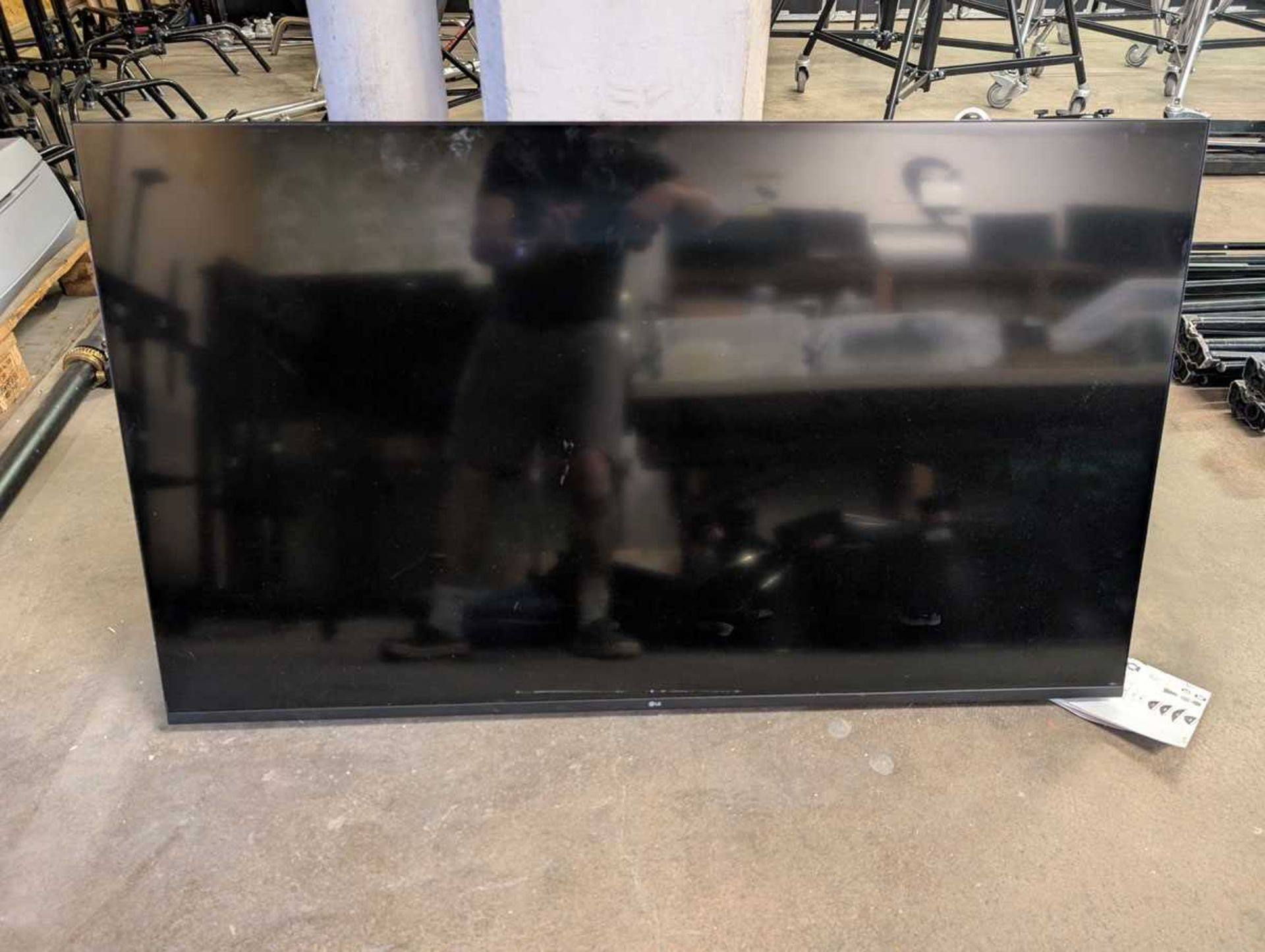 +VAT LG 55UR73006LA flat screen TV on mobile stand