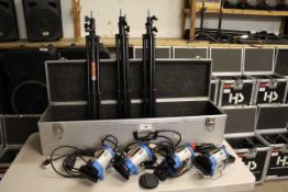 +VAT Set of four Arri 150 Junior series spotlights with associated tripod stands in flight case
