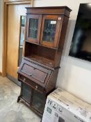 Mahogany bureau with lower glass doors and upper stained glass doors and shelves, with key